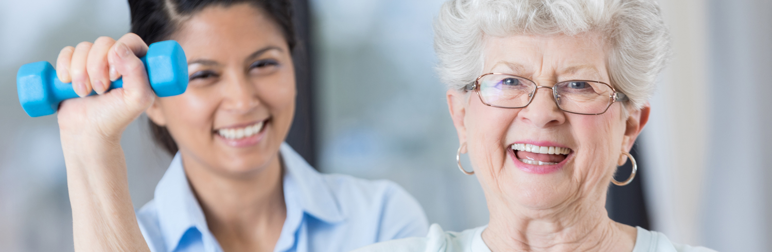 Physical therapist and patient with barbell