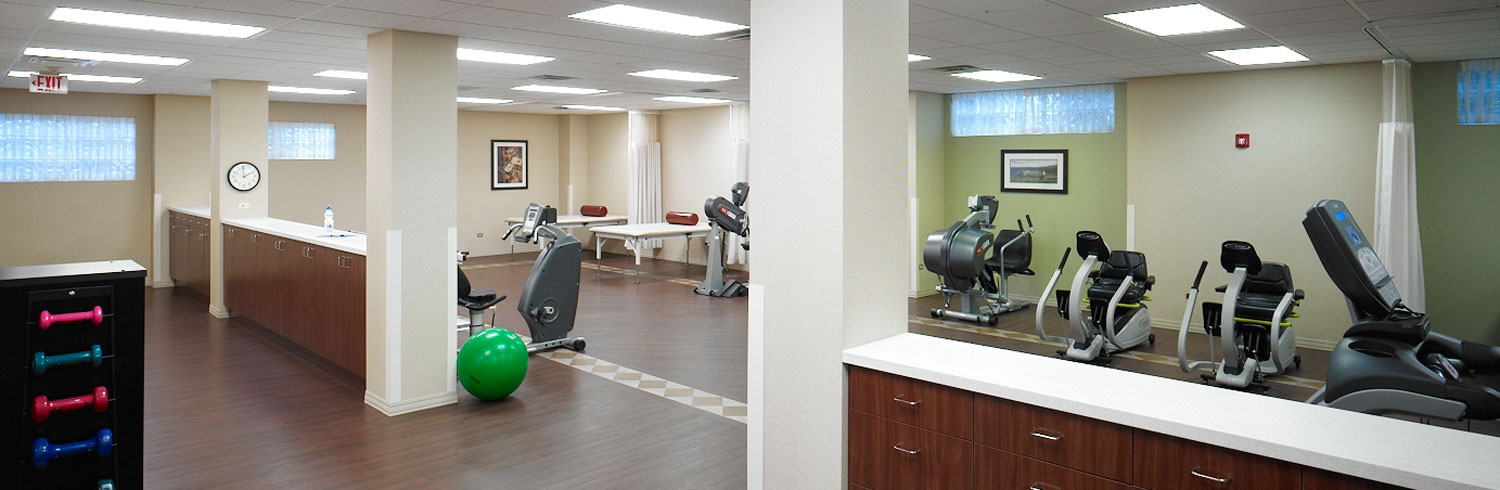 Bright gym with various workout equipment and fitness tools.